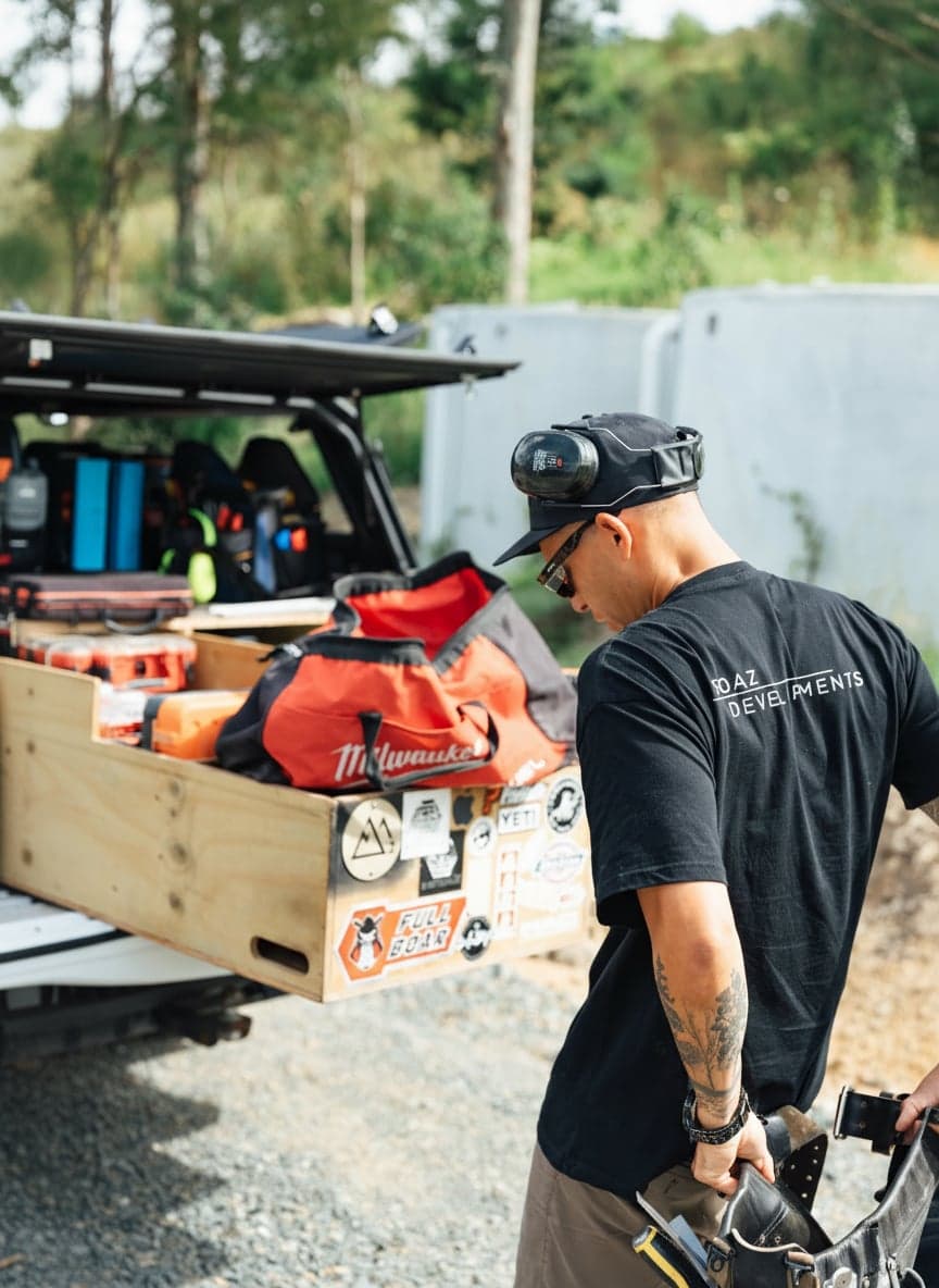 Boaz Developments builder loading tools at a Northland job site - a local builder showing up on the ground